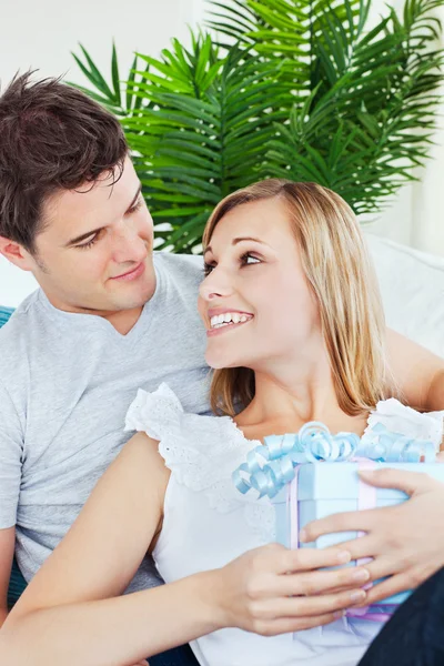 Schöne Frau sieht seinen Freund an, nachdem sie ein Geschenk erhalten hat — Stockfoto