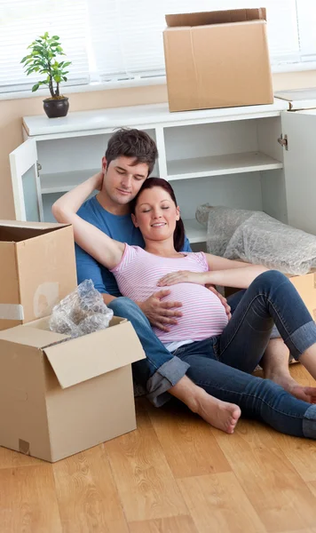 Future parents relaxing on the floor during a break after unpack — Stock Photo, Image