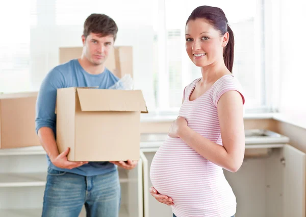 Gravid kvinna med sin man i sitt nya kök under remo — Stockfoto