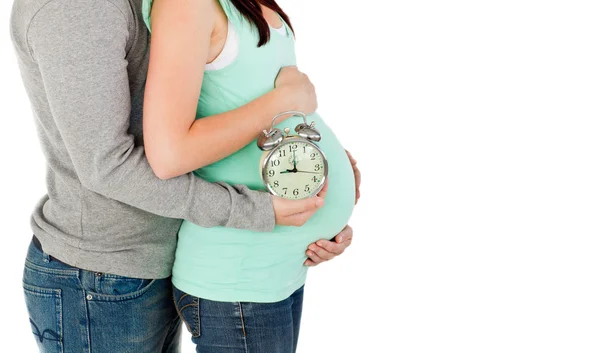 Close-up of loving future parents holding a clock — Stock Photo, Image