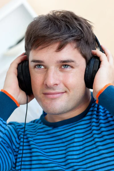英俊的男人用耳机听音乐的肖像 — 图库照片
