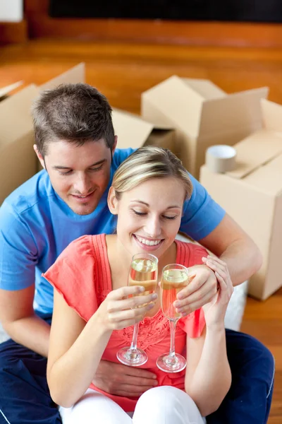 Young couple celebrating their removal with champagne — Stock Photo, Image