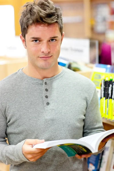 Serious young man reading a book — Stock Photo, Image