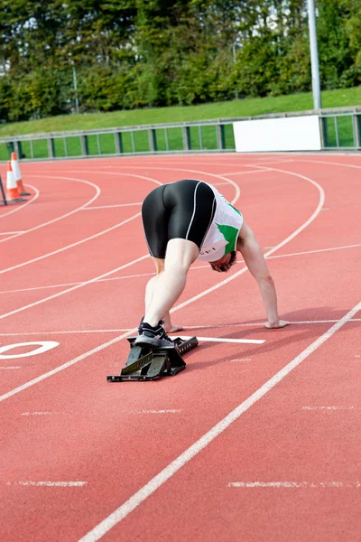 Concentrated man waiting in starting block — Stock Photo, Image