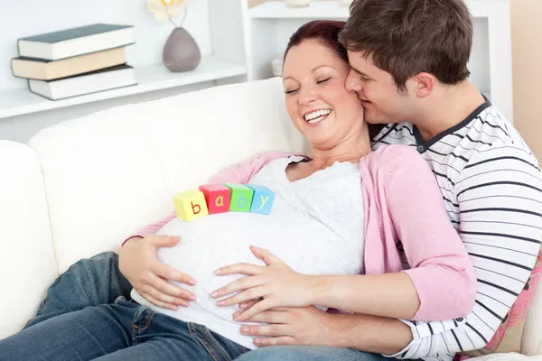 Portrait of a happy pregnant woman with baby cubes on her belly — Stock Photo, Image