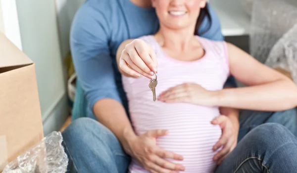 Close-up of a lovely couple expecting a baby sitting on the floo — Stock Photo, Image