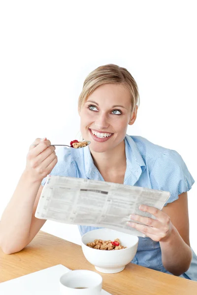 Glowing businesswoman having breakfast and reading a newspaper s — Stock Photo, Image