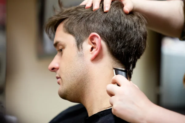 Cabeleireiro cortando o cabelo de seu cliente — Fotografia de Stock