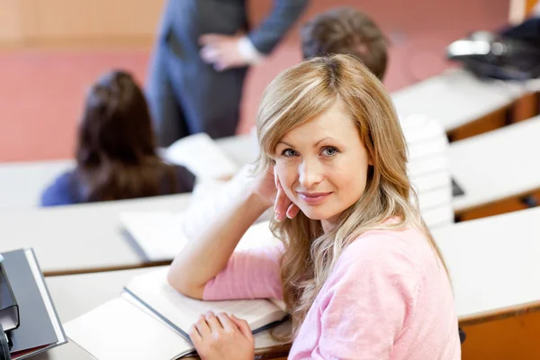 Serious students listening to their teacher at university — Zdjęcie stockowe