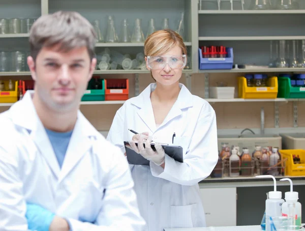 Two assertive scientists looking at the camera standing — Stock Photo, Image