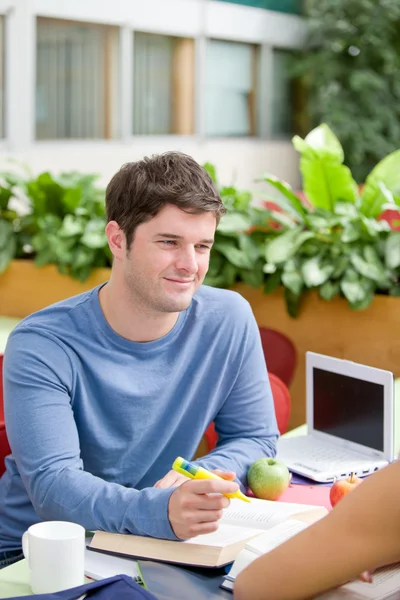 Portrait of a confident student working with his friend — Stock Photo, Image