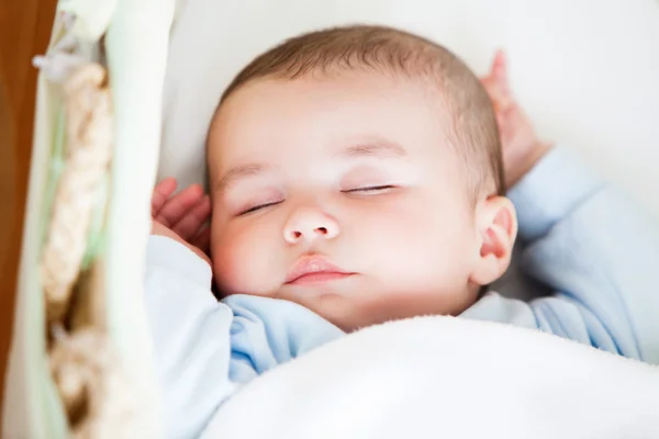 Portrait of a sleeping baby lying in his cradle — Stock Photo, Image