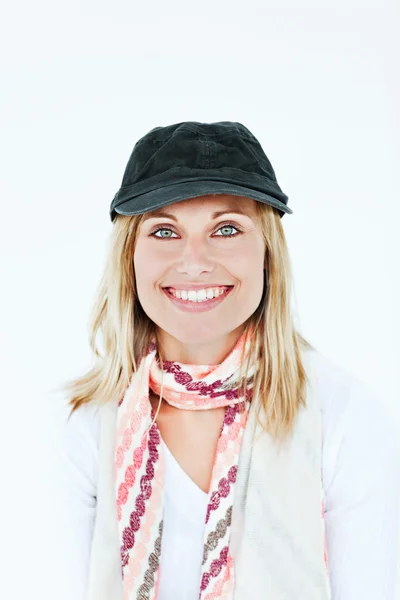 Beautiful blond woman with cap and scarf smiling at the camera a — Stock Photo, Image