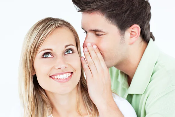 Young man whispering something to his attentive female friend — Stock Photo, Image