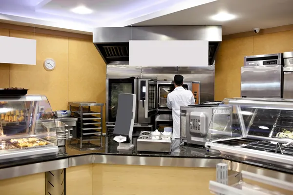 Blick in eine Küche mit Bäcker, der Brot und Baguette in einem — Stockfoto