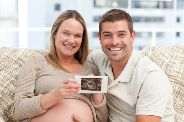 Joyful future parents looking at an echography together — Stock Photo, Image