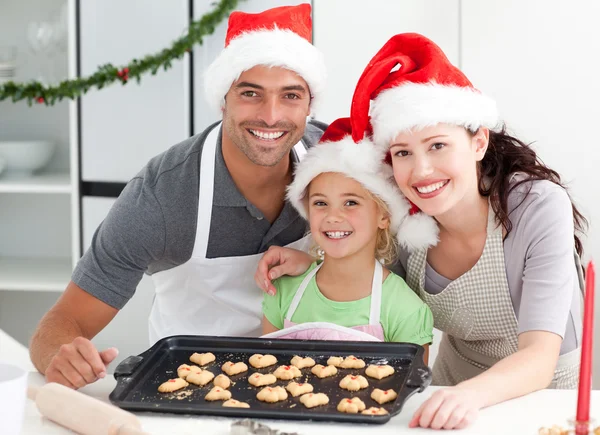 Счастливая женщина с мужем и дочерью их печенье готово — стоковое фото