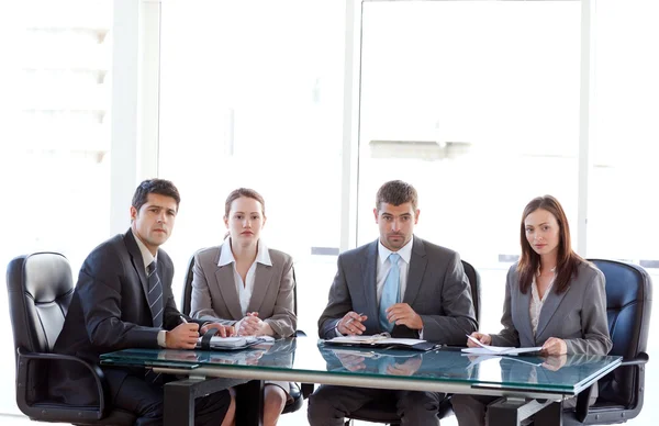Businessteam looking at the camera during a presentation — Stock Photo, Image