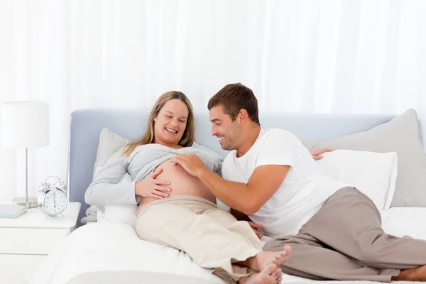Leuk spelen met zijn zwangere vrouw man — Stockfoto