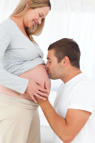Adorable future dad kissing the belly of his wife — Stock Photo, Image