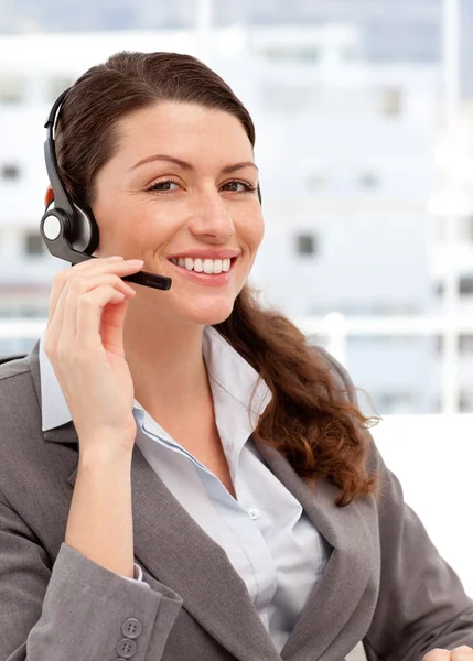 Smiling woman talking on the headphones — Stock Photo, Image