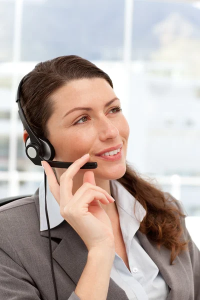 Pensive businesswoman talking on the phones using headphones — Stock Photo, Image