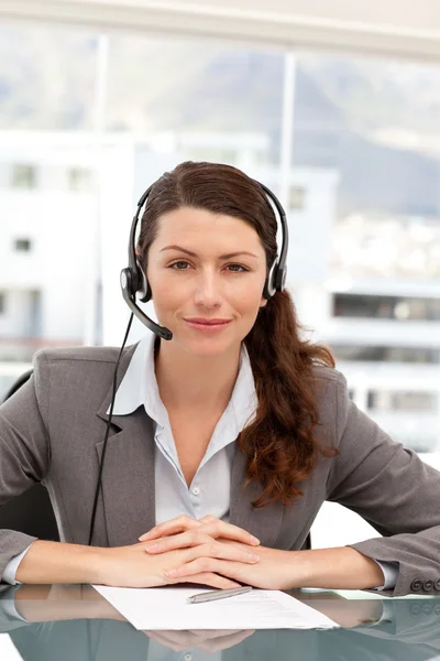 Portrait of a charismatic businesswoman with earpiece — Stock Photo, Image