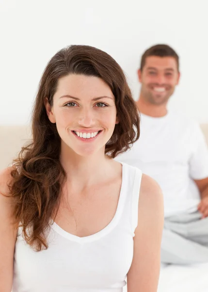Adorable woman sitting on her bed with her boyfriend — Stock Photo, Image