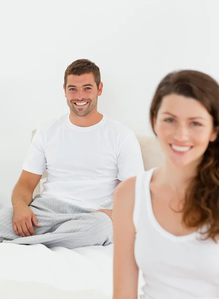 Cheerful couple relaxing together in their bedroom in the mornin — Stock Photo, Image