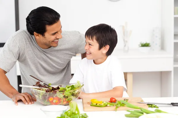 Adorable father and son looking at each other in the kitchen — Stock Photo, Image