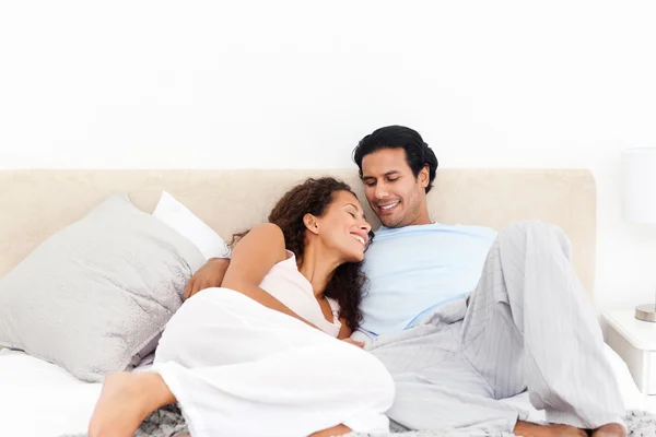 Adorável casal hispânico relaxante em seu quarto — Fotografia de Stock