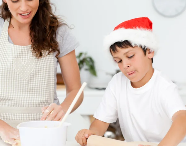 Cute boy preparing christmas biscuits with his mother — Stock Photo, Image