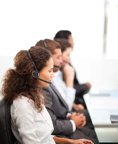 Four representatives on the phones with earpiece on — Stock Photo, Image