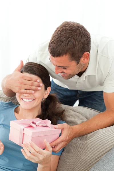 stock image Happy woman receiving a gift from her boyfriend in the living ro