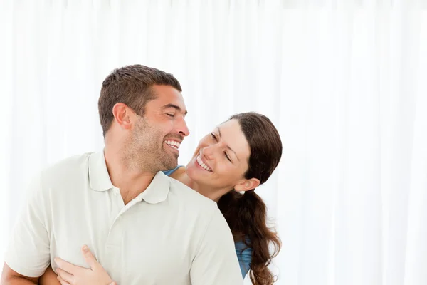 Adorável casal rindo juntos na sala de estar — Fotografia de Stock