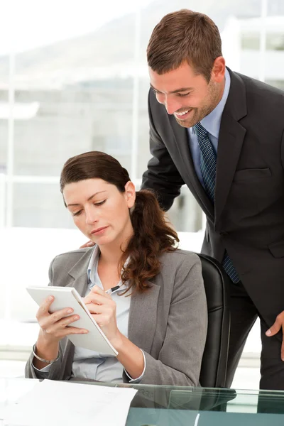 Concentrated woman taking notes whiletalking to her manager — Stock Photo, Image