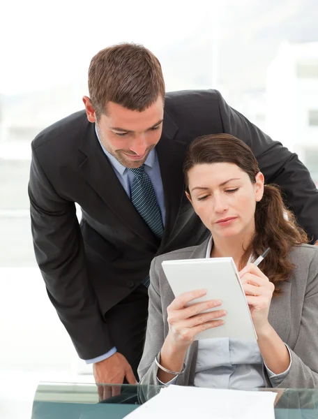 Handsome businessman speaking to a female colleague — Stock Photo, Image