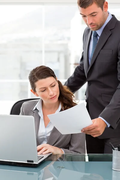 Bel manager che mostra un documento a una donna d'affari mentre lavora — Foto Stock
