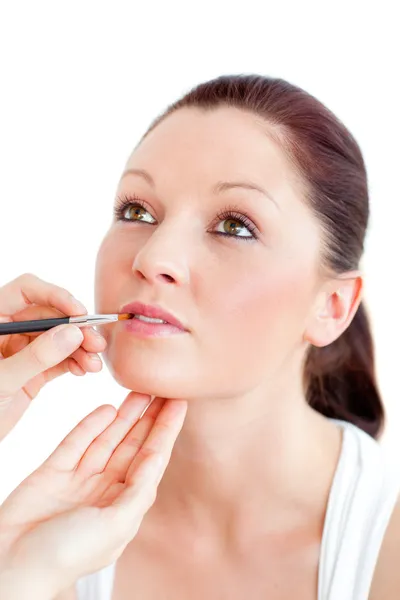 Concentrated woman being made-up by a professional artist Royalty Free Stock Images