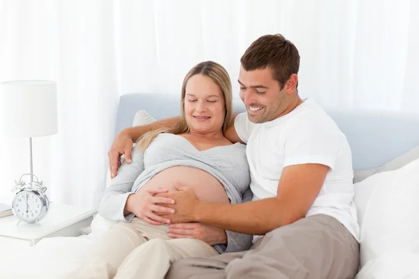 Future parents resting in the bedroom Stock Image