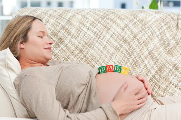 Pretty future mom with baby letters on the belly Royalty Free Stock Images