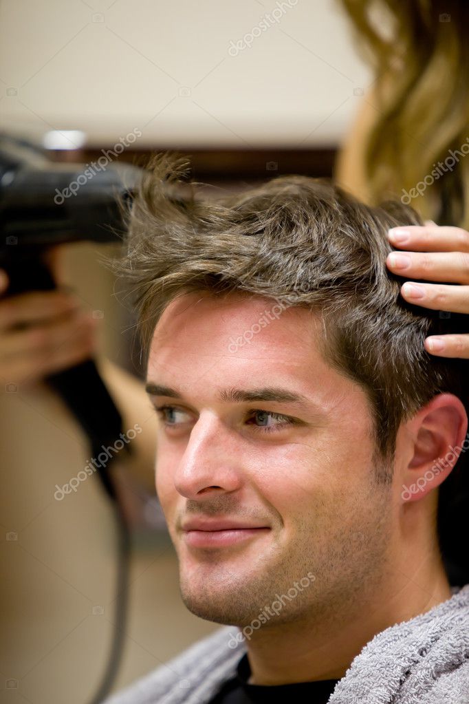 Female hairdresser drying her male customer's hair Stock Photo by  ©Wavebreakmedia 10837483