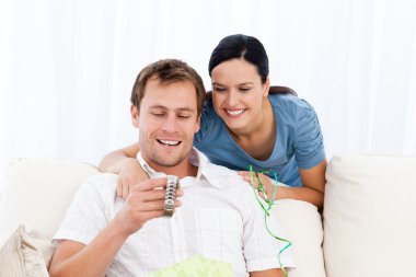 Happy man looking at a watch given by his girlfriend clipart