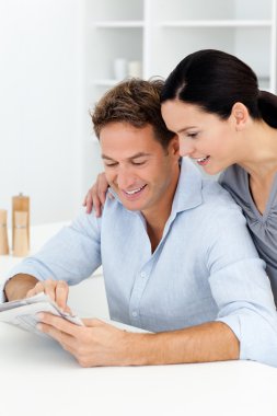 Lovely couple looking at something on the newspaper clipart