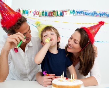 Happy family having fun during a birthday clipart