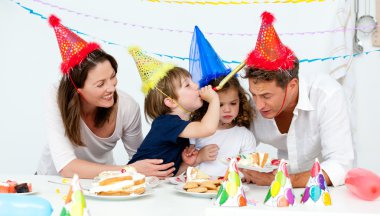 Happy family having fn while eating birthday cake clipart