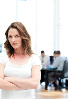 Confident woman standing at a meeting clipart