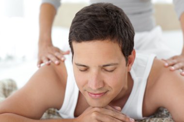 Peaceful being massaged by his girlfriend on their bed clipart