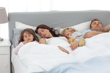 Relaxed family doing a nap together clipart