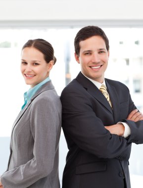 Happy businessman and businesswoman posing back to back clipart